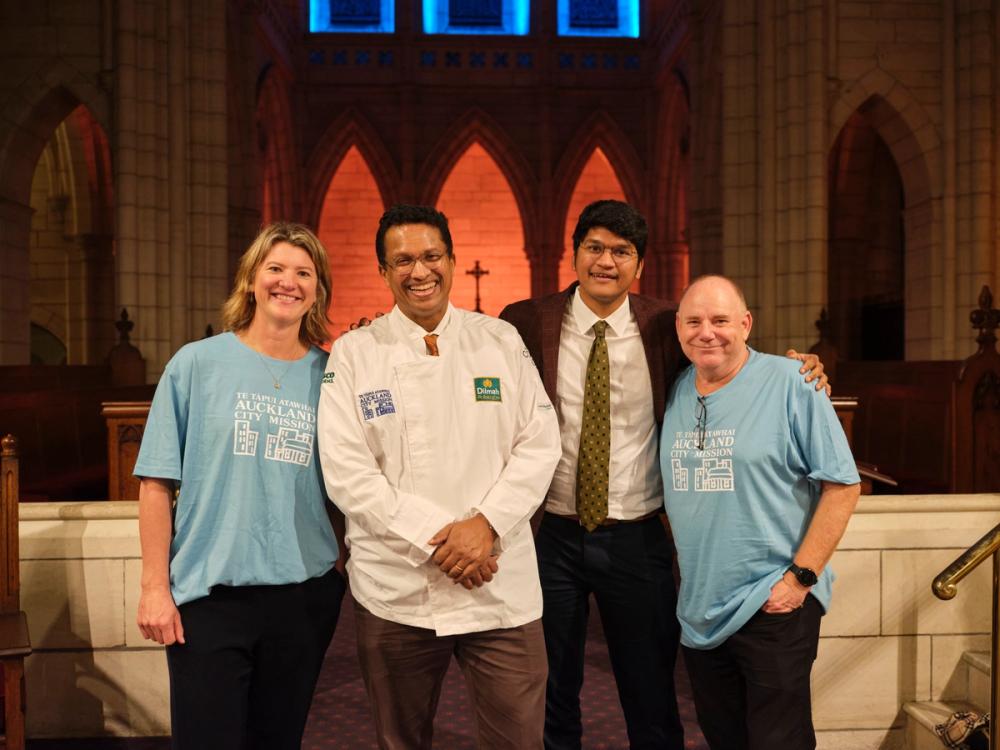 four people grouped together looking at the camera