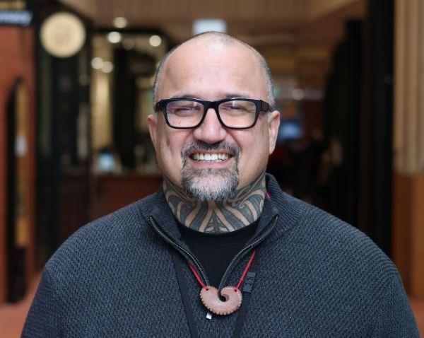 a man smiling at the camera .