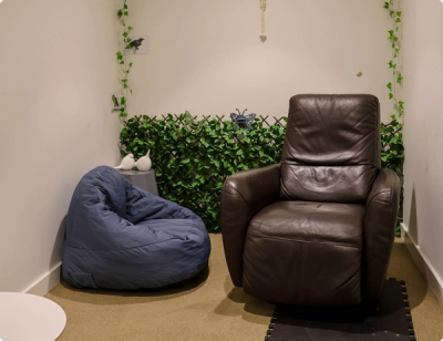 a room with a bean bag chair and a recliner