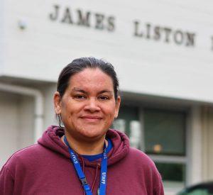 a woman standing in front of a building .
