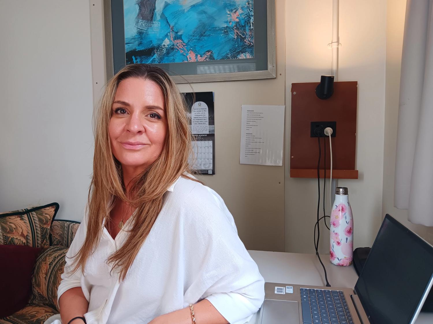 lady smiling at camera in office setting