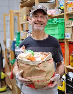 a man holds a box of food