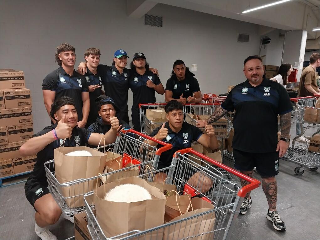 a woman wearing an apron is smiling in a kitchen
