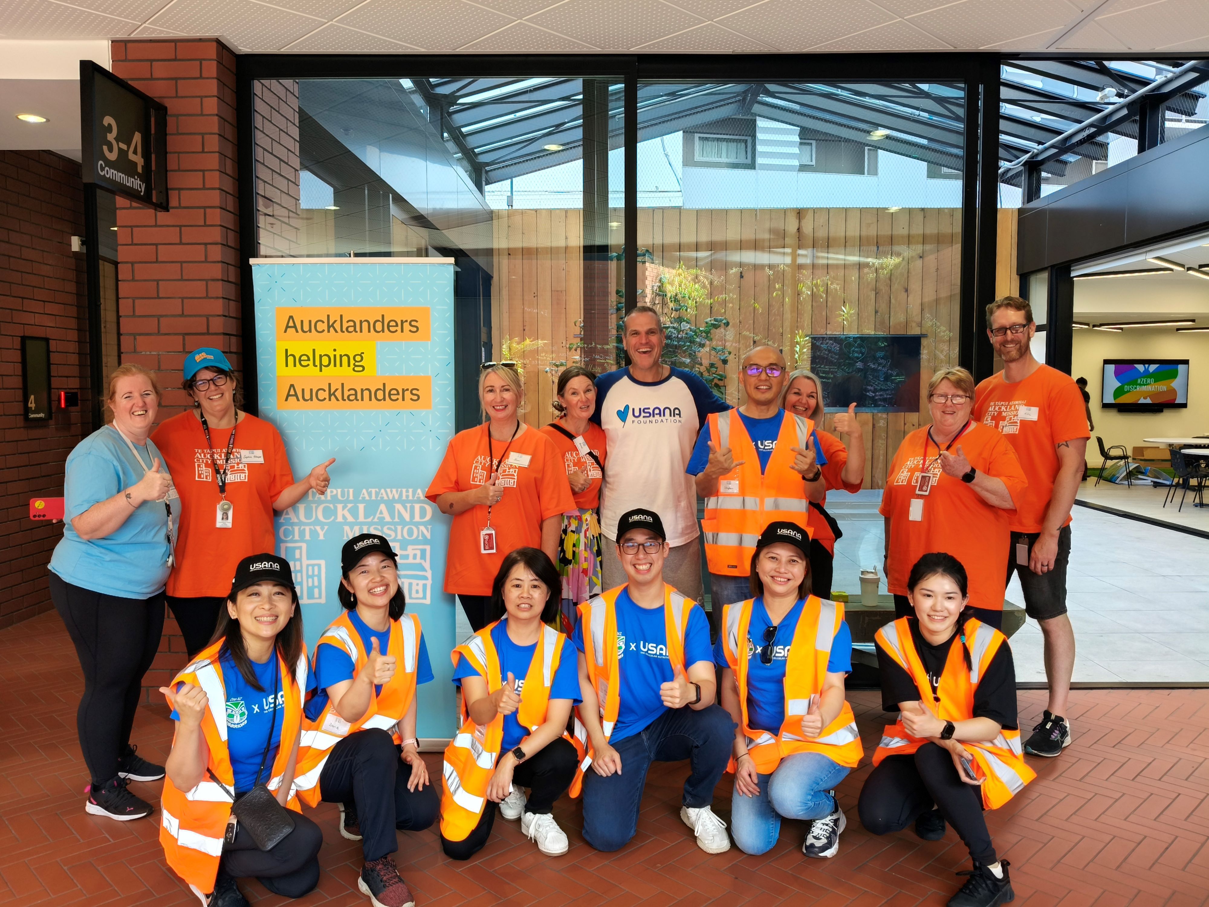 a woman in an apron holds a bottle of oat milk