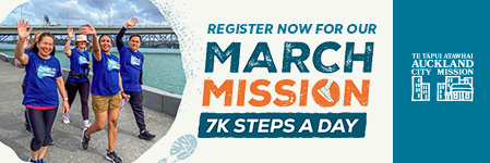 a woman smiling at the camera holding a box of donated food