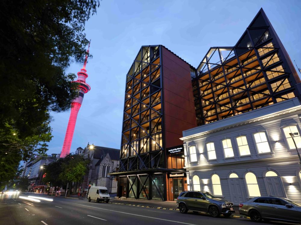 a big building with the sky tower in background .