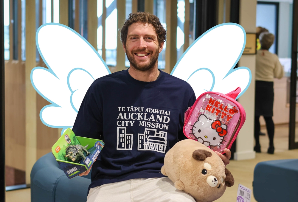 a man wearing a shirt that says auckland city mission