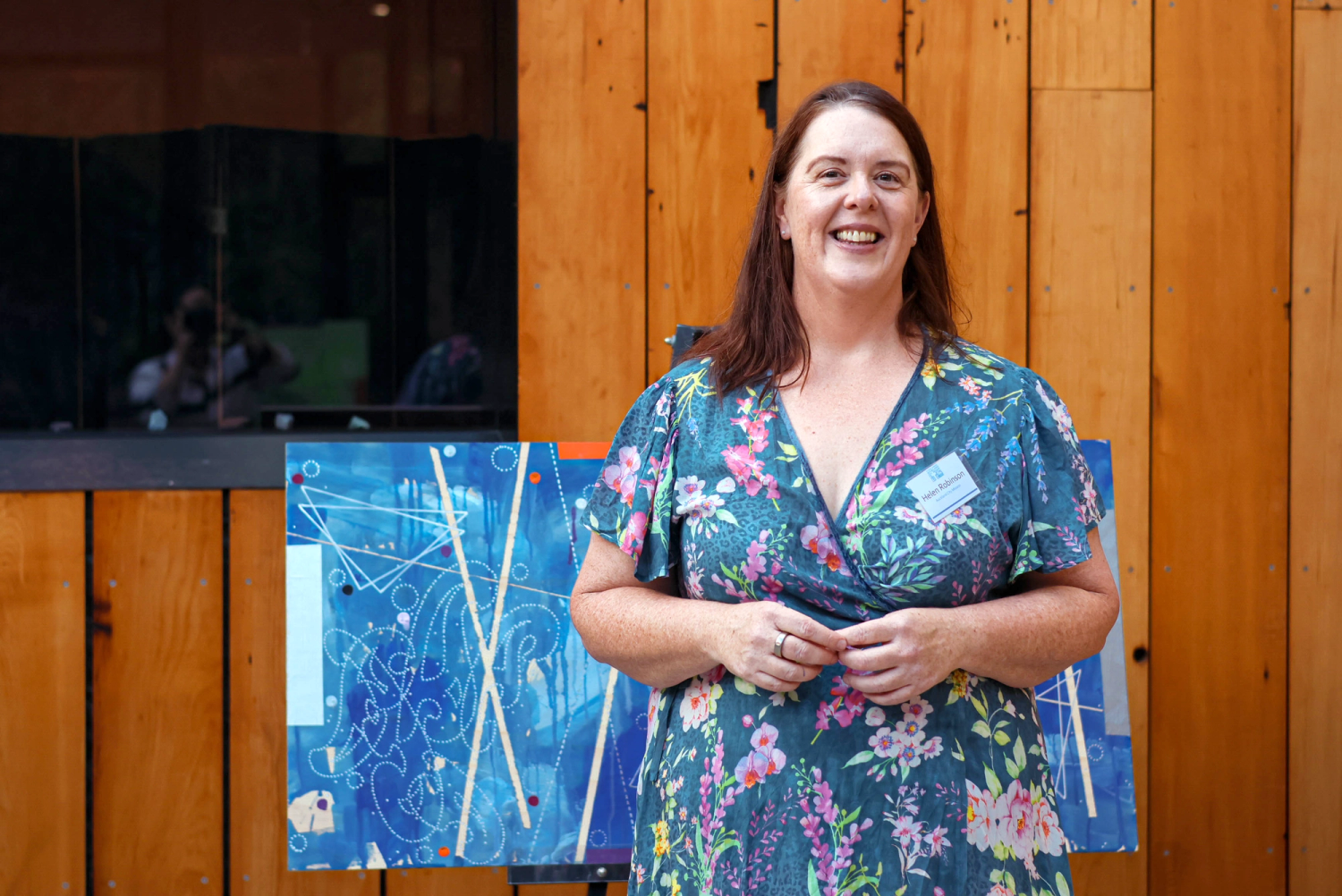 a woman in a floral dress has a name tag that says ' amanda ' on it