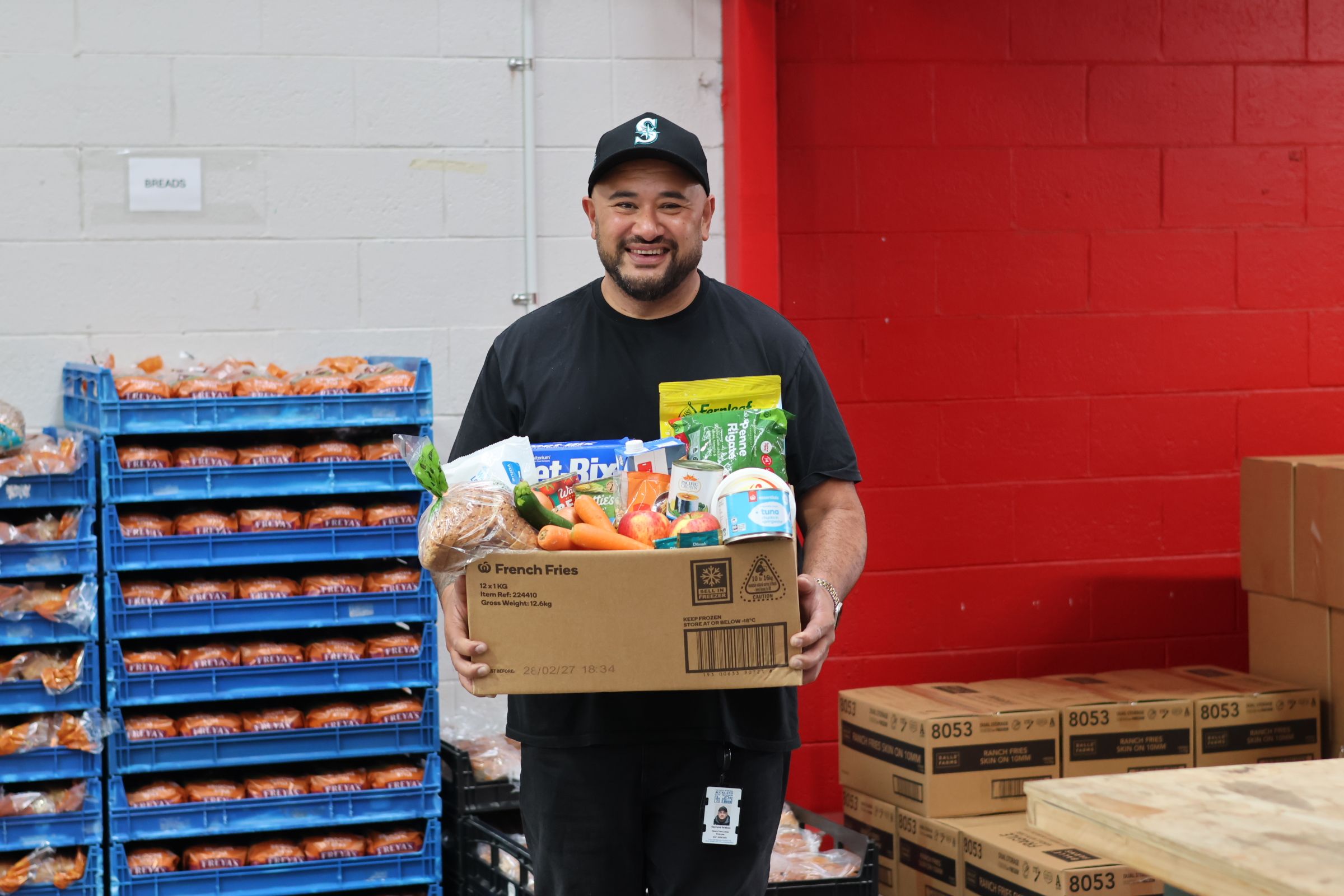 a man is holding a box full of food