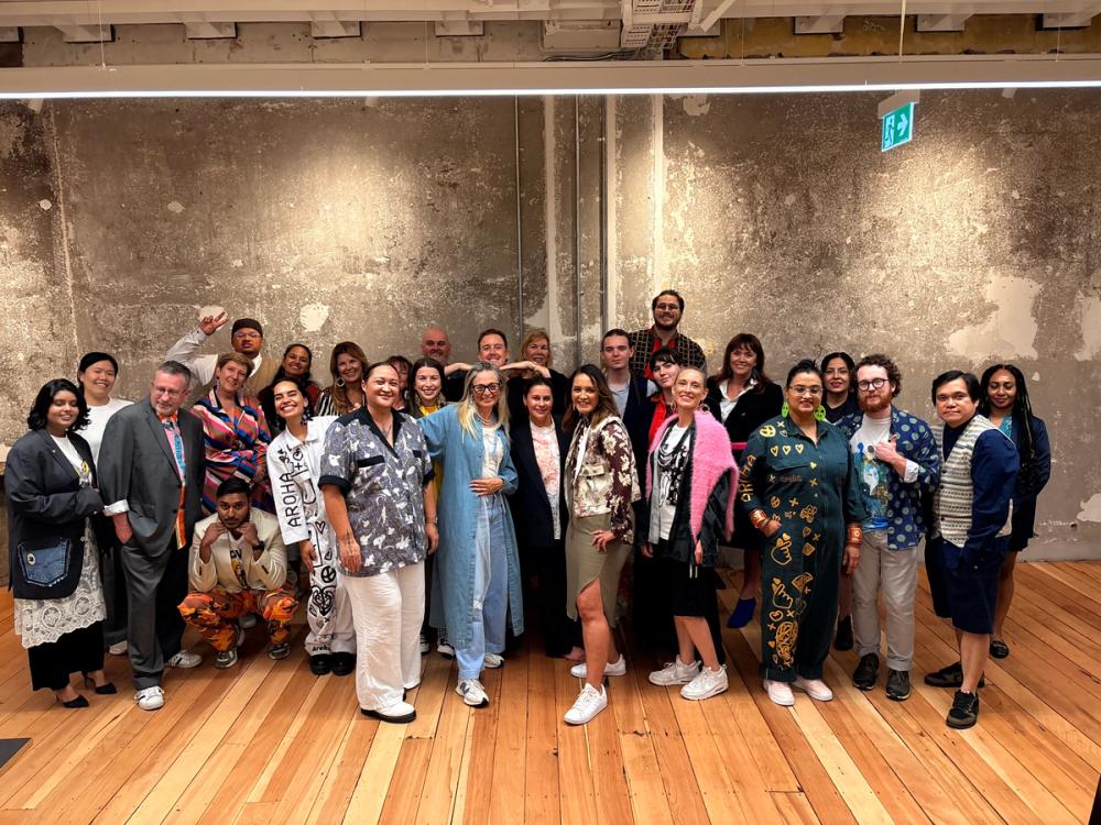 a row of jeans hanging on a rack in a store .
