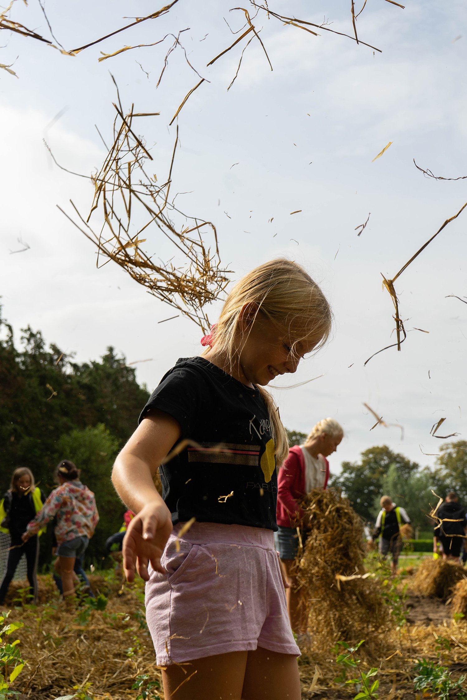 girl throwing hay