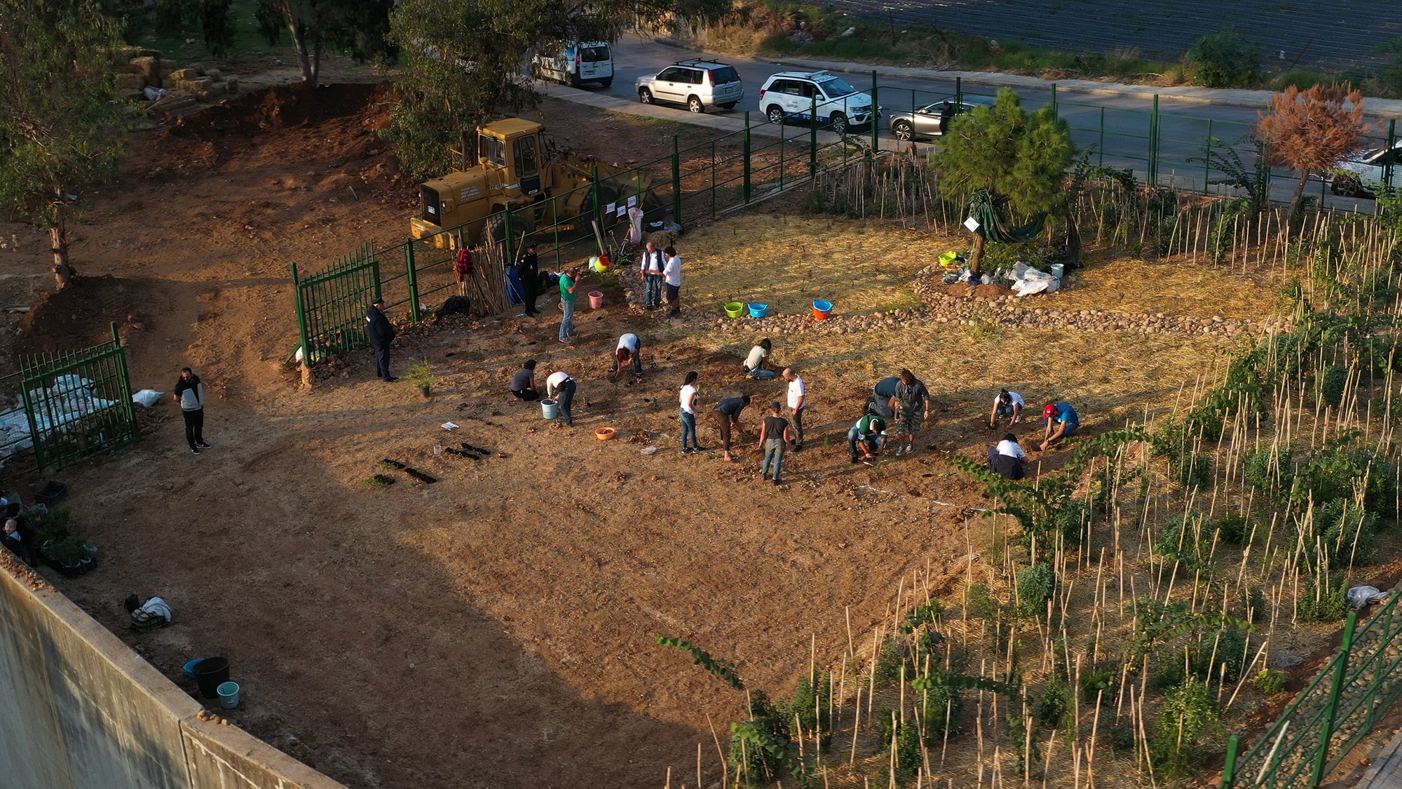 people stand in a dirt field
