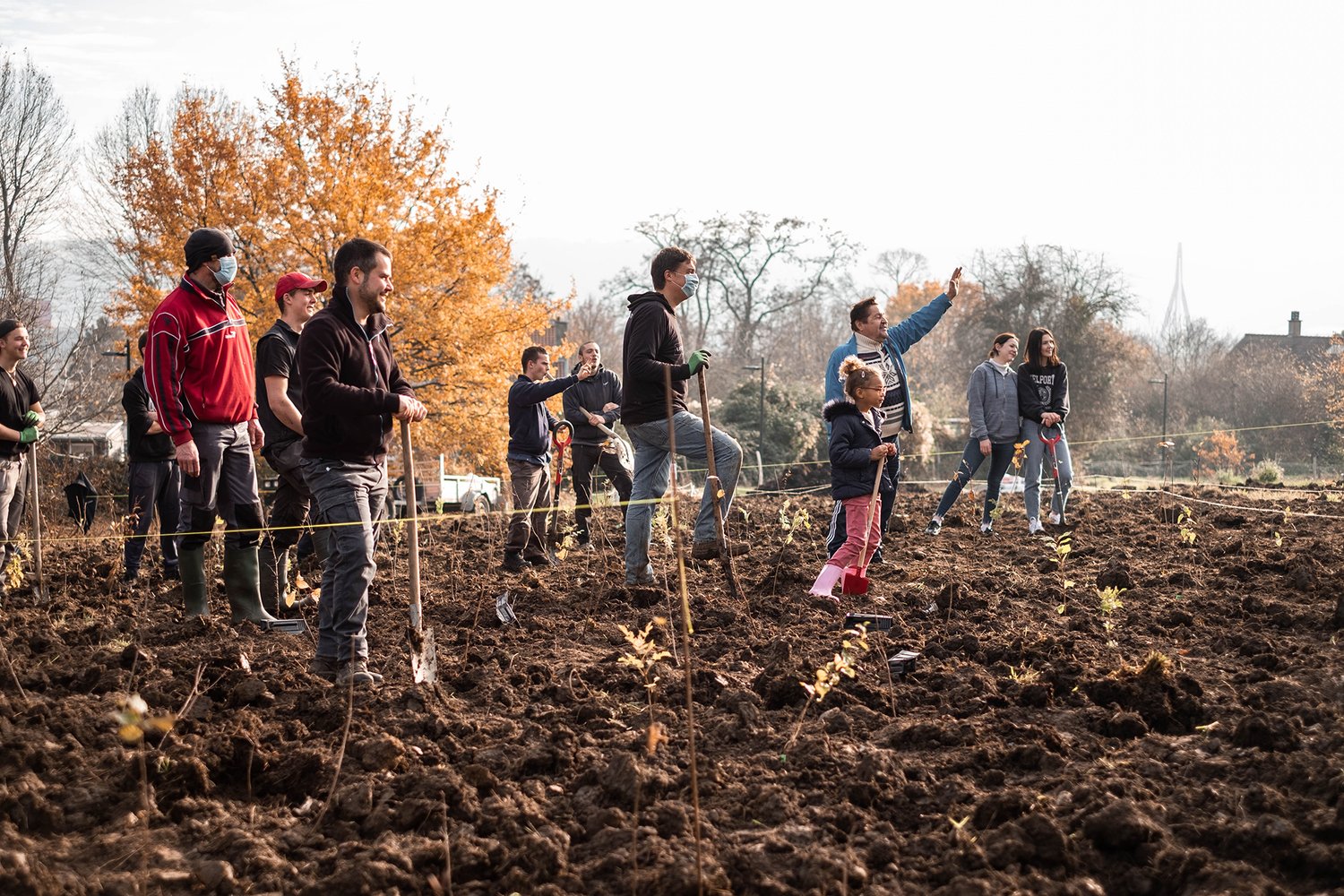 people stand in a dirt field