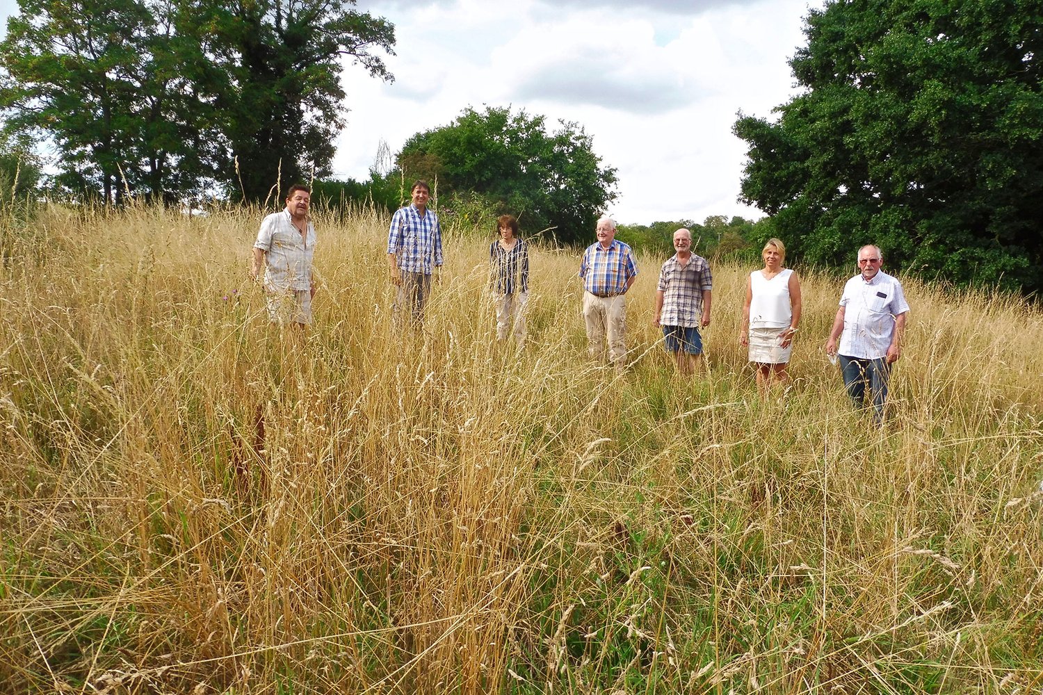 people stand in a dirt field