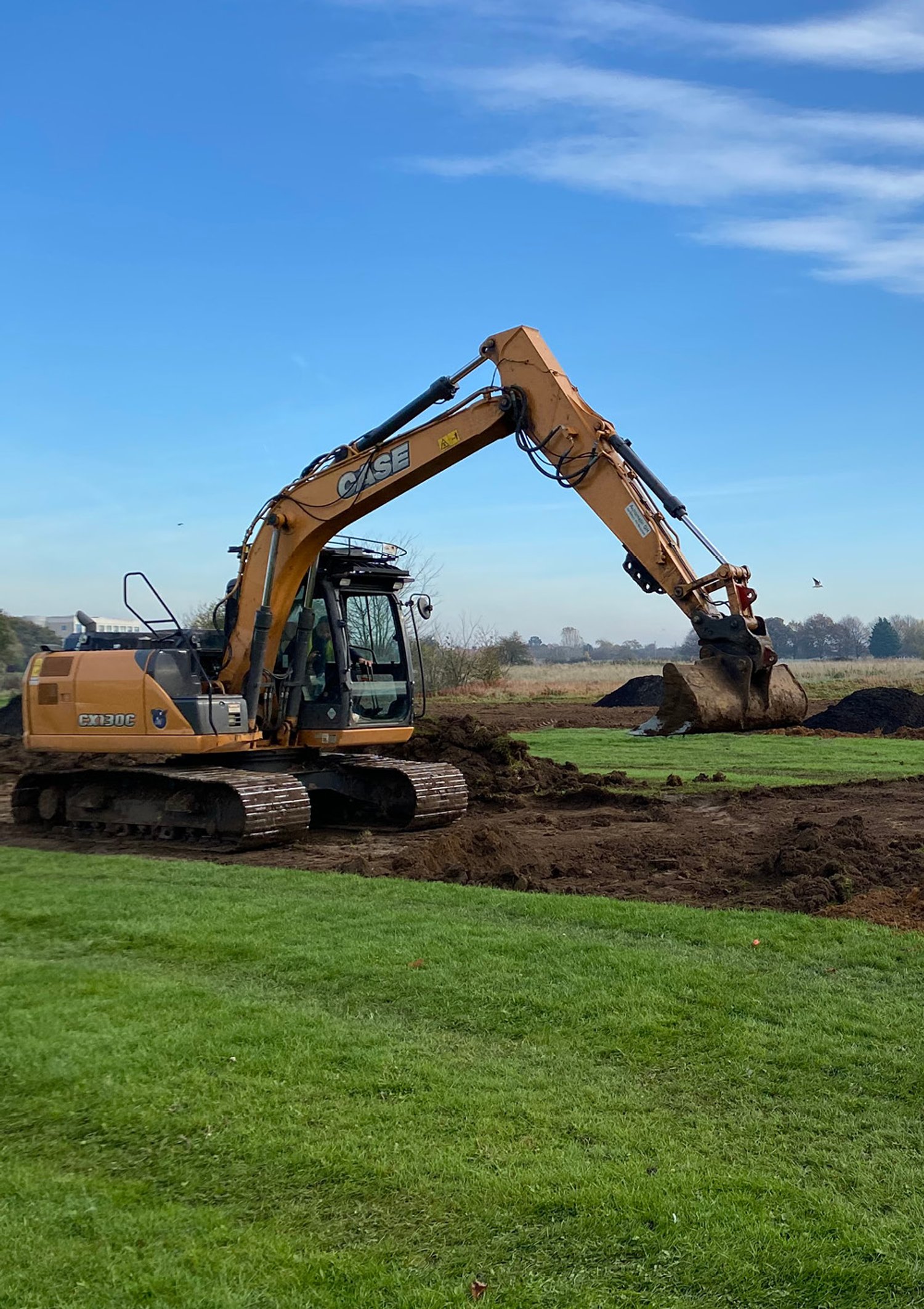 An excavator digs in the dirt