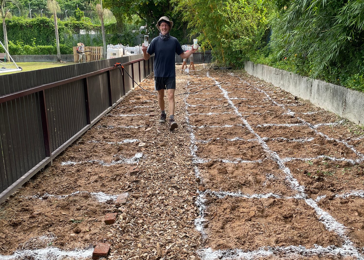 man stands in a dirt field