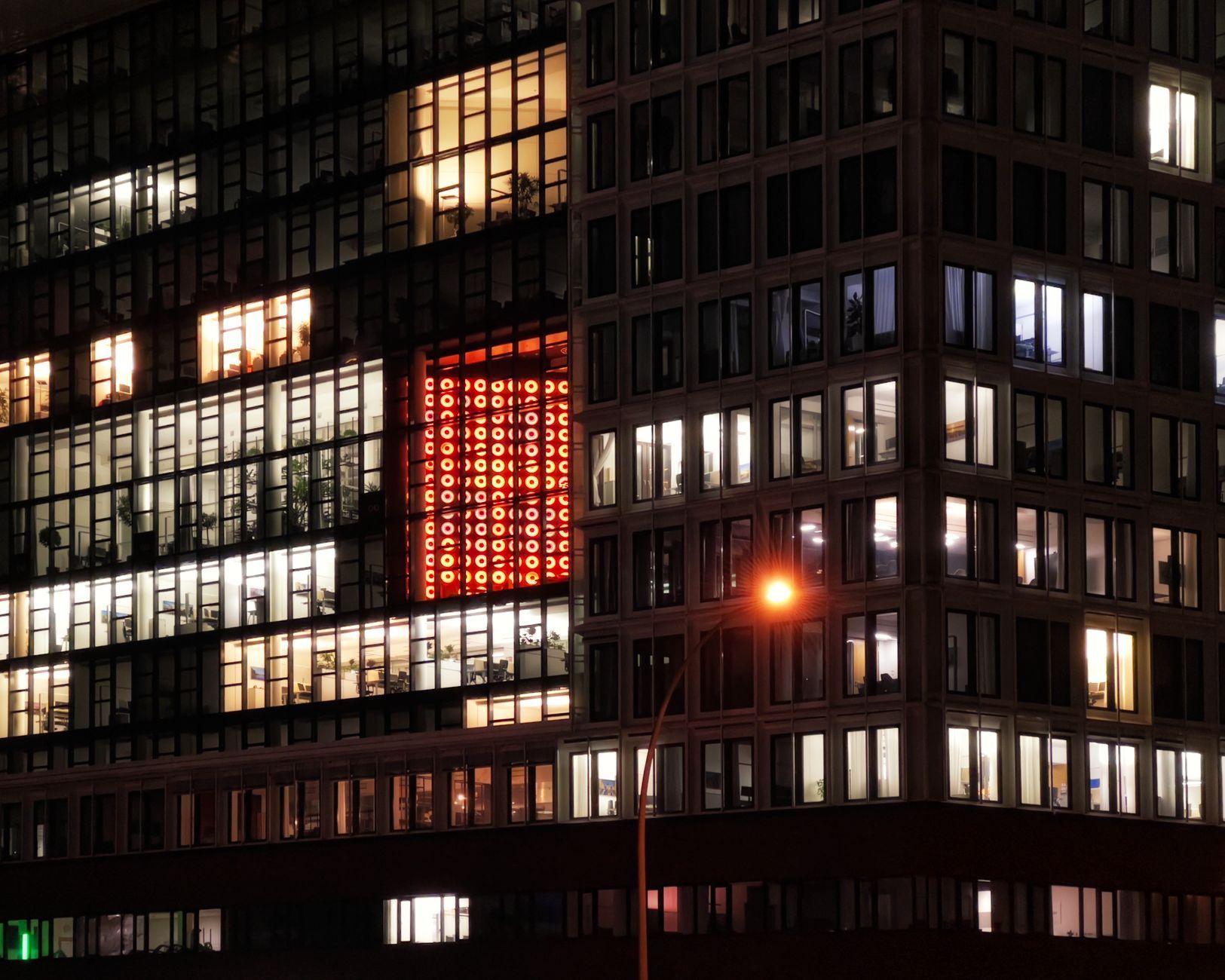 City office towers lit at night representing round-the-clock support