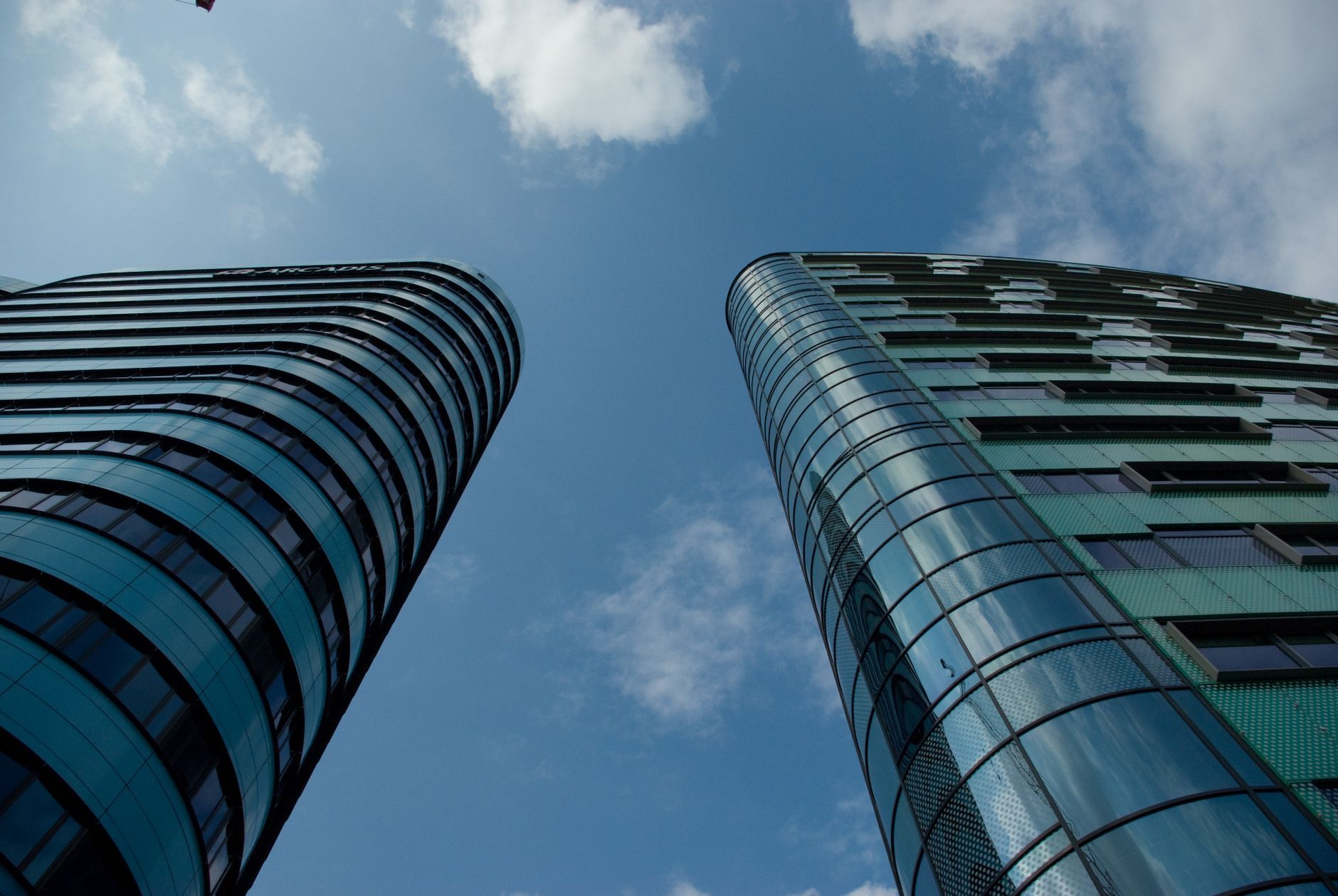 Low angle view of modern glass skyscrapers against a clear blue sky