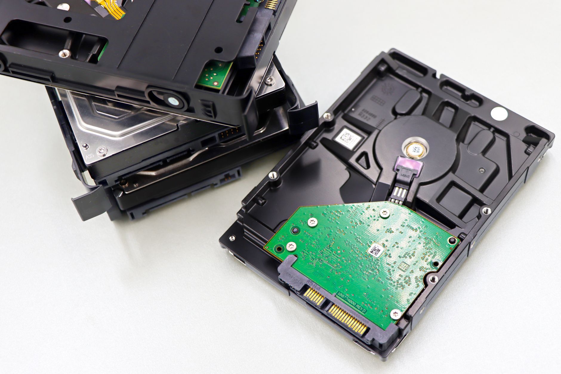 Dismantled hard disk drives laid out for data destruction and disposal