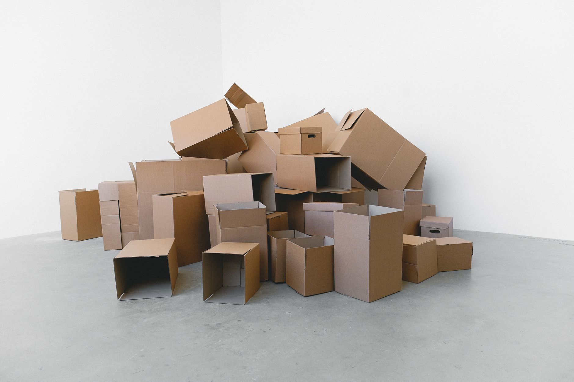 Stacked cardboard boxes on a floor, representing packing and moving equipment