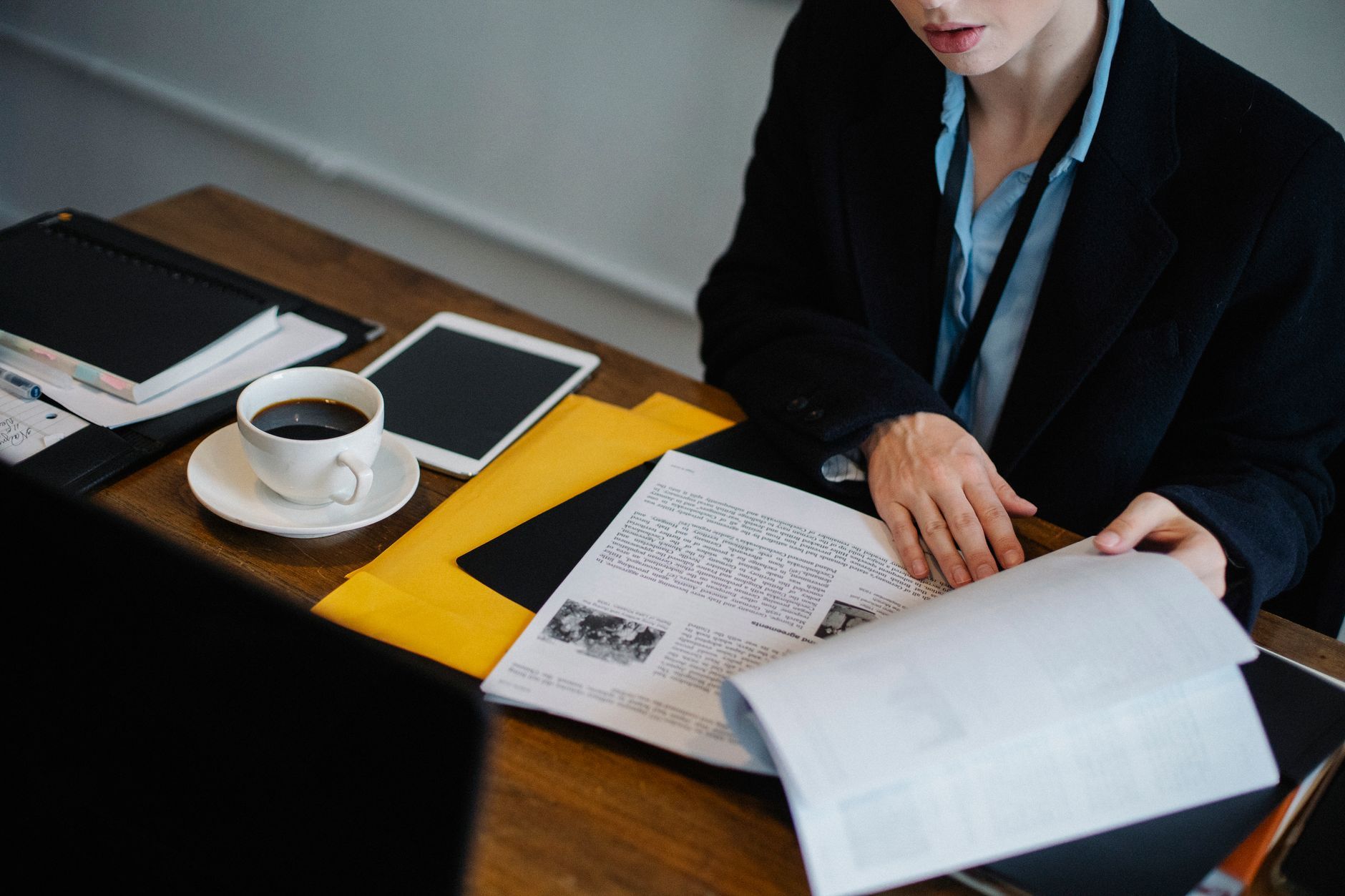 Security consultant comparing two versions of a configuration checklist at a desk