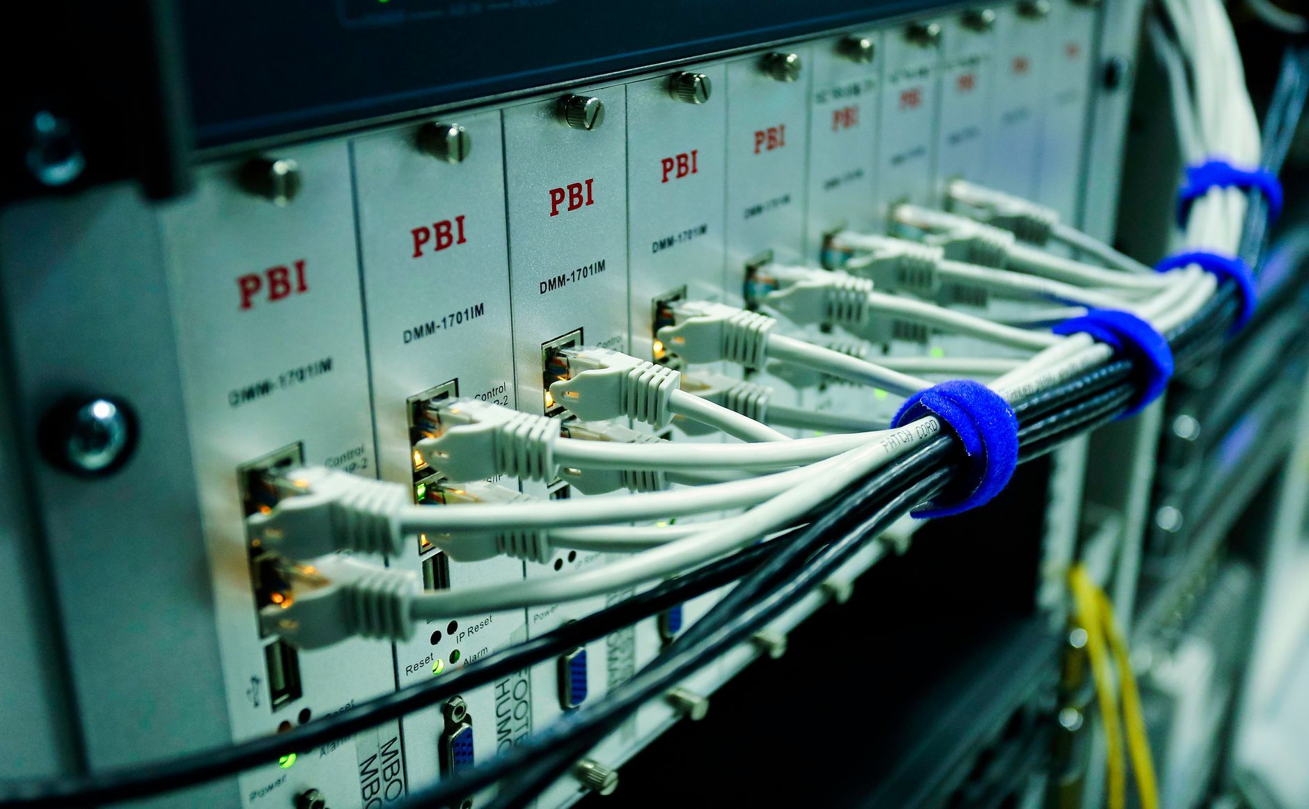 Close-up of ethernet cables plugged into a network switch panel, representing the firewall and network perimeter behind a Hong Kong manufacturer's internet connection
