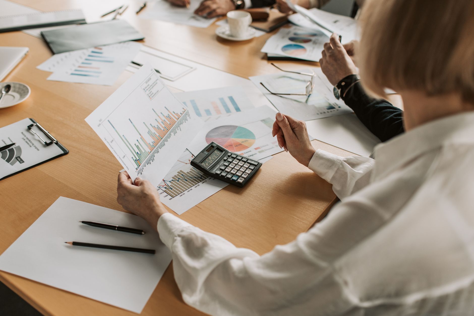 A business team reviewing financial charts and growth data together in an office meeting, representing the operating-margin decisions behind a growing company's IT spend