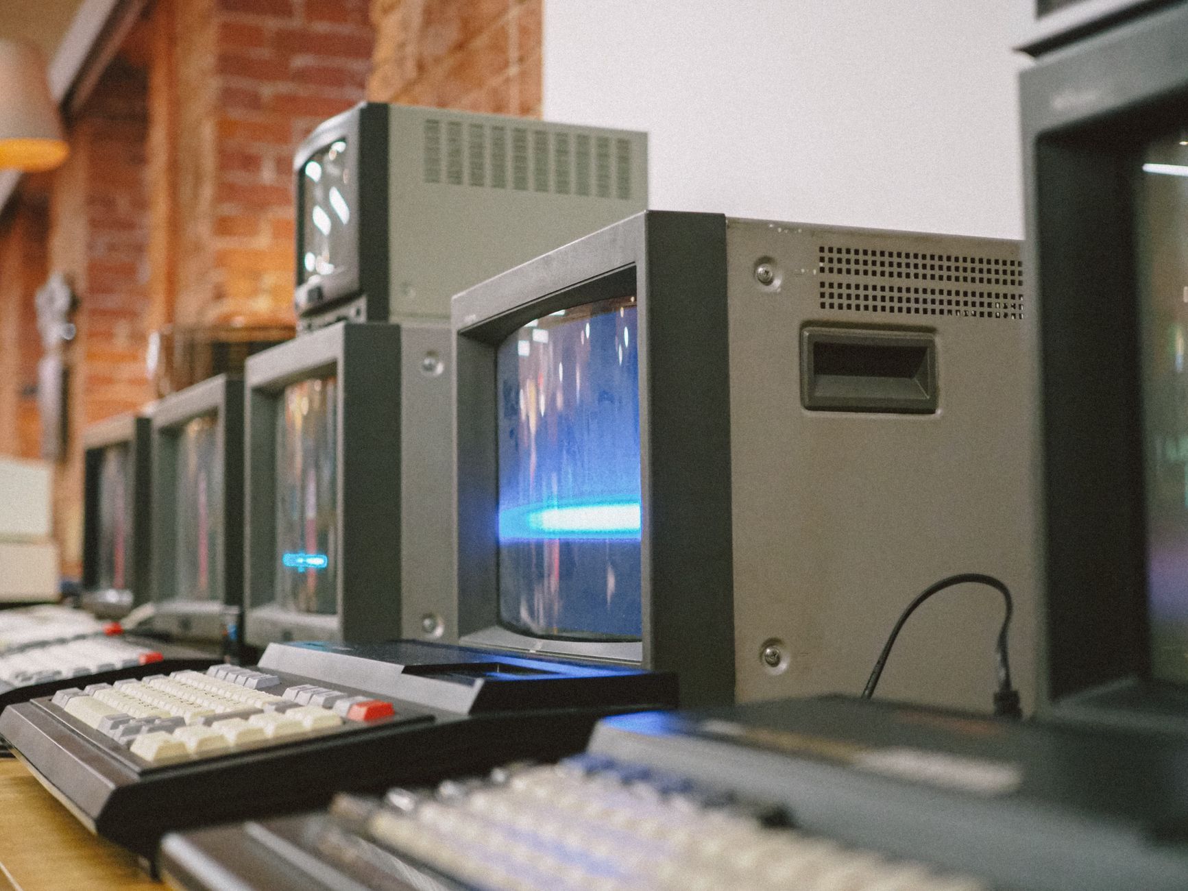 Row of vintage CRT computer monitors, symbolising ageing IT equipment