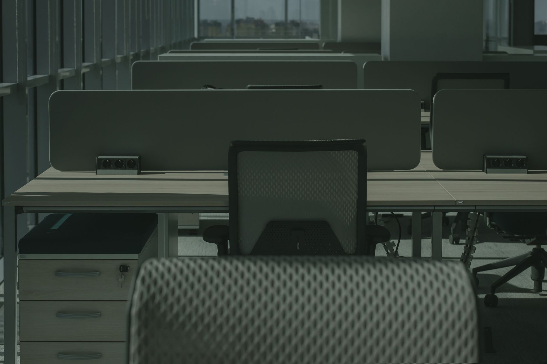 Empty modern open-plan office with rows of desks and chairs, ready for a new IT build-out