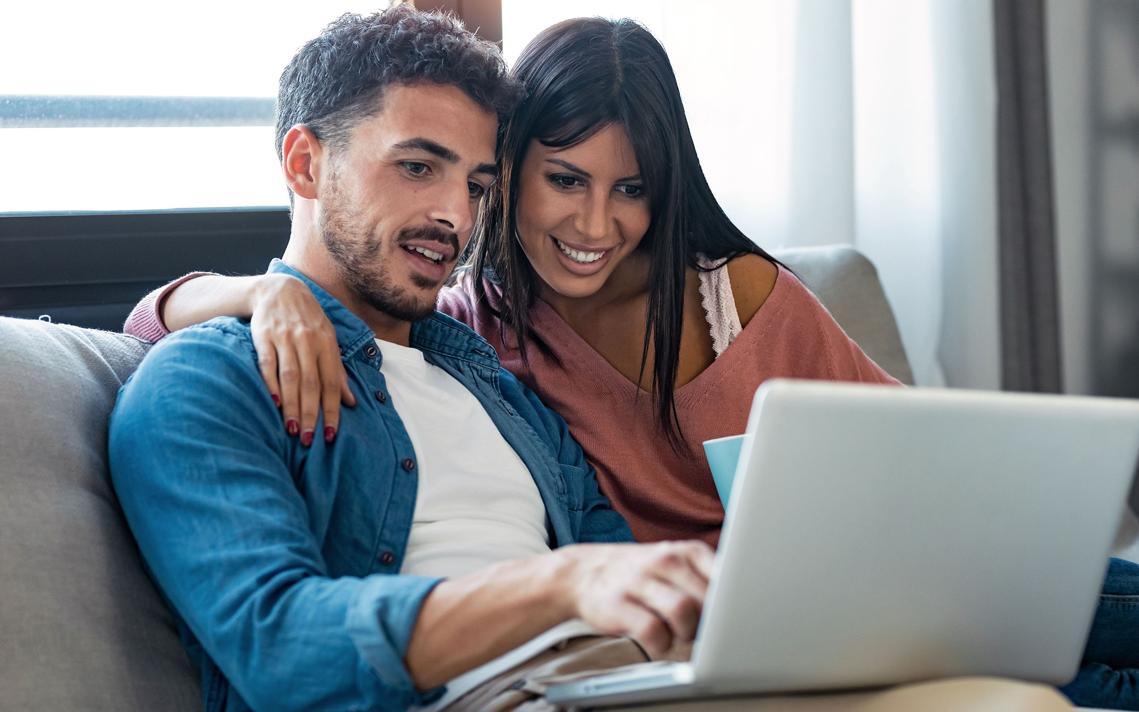 happy couple shopping on a computer