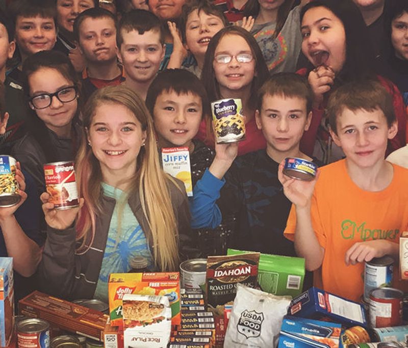 volunteering kids holding donations