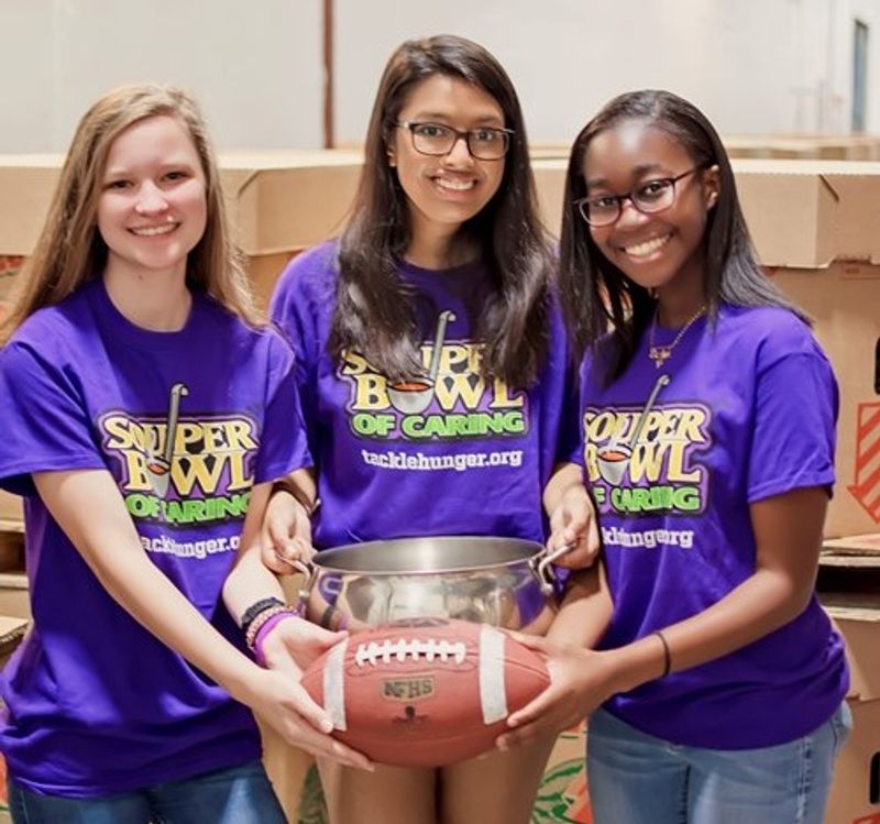 volunteers holding football