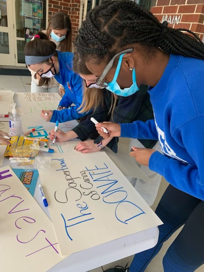 participants making signs for their fundraiser
