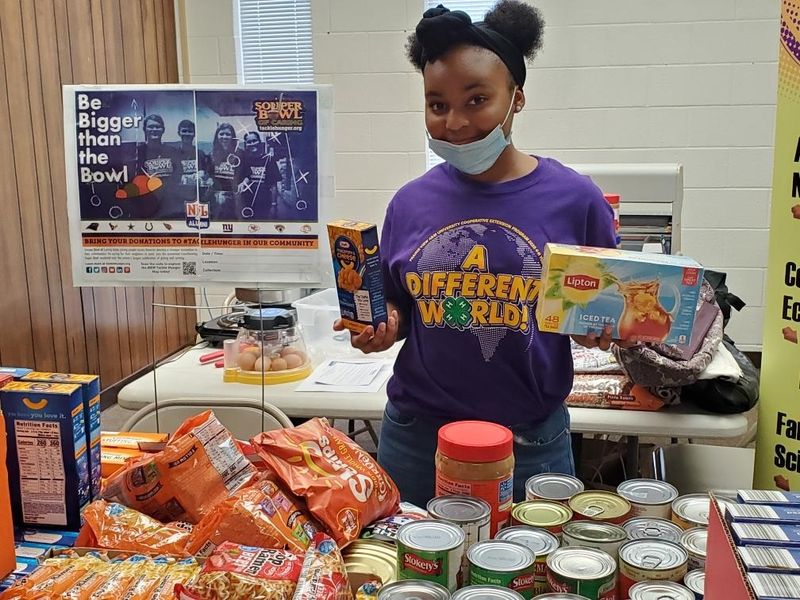 girl holding a Food drive 