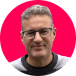 Headshot of Alastair Wilkinson with pink background