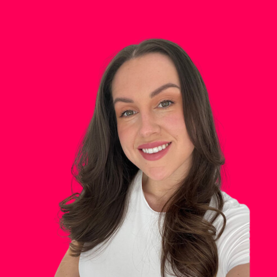 kirsty lewis has brown hair, is wearing a white top with a pink background