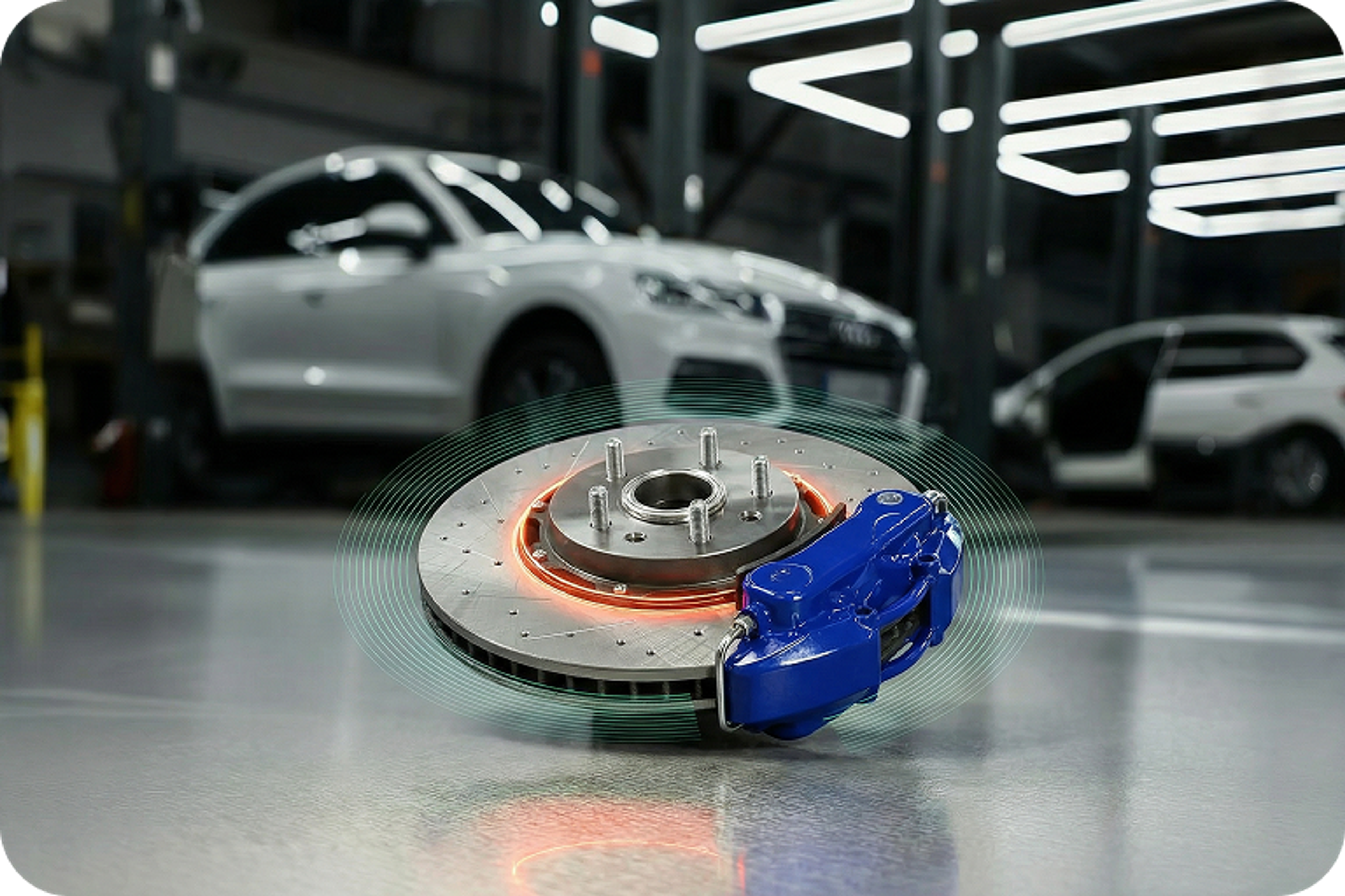 Disc brake with caliper and brake disc, shown in a modern workshop with vehicles in the background