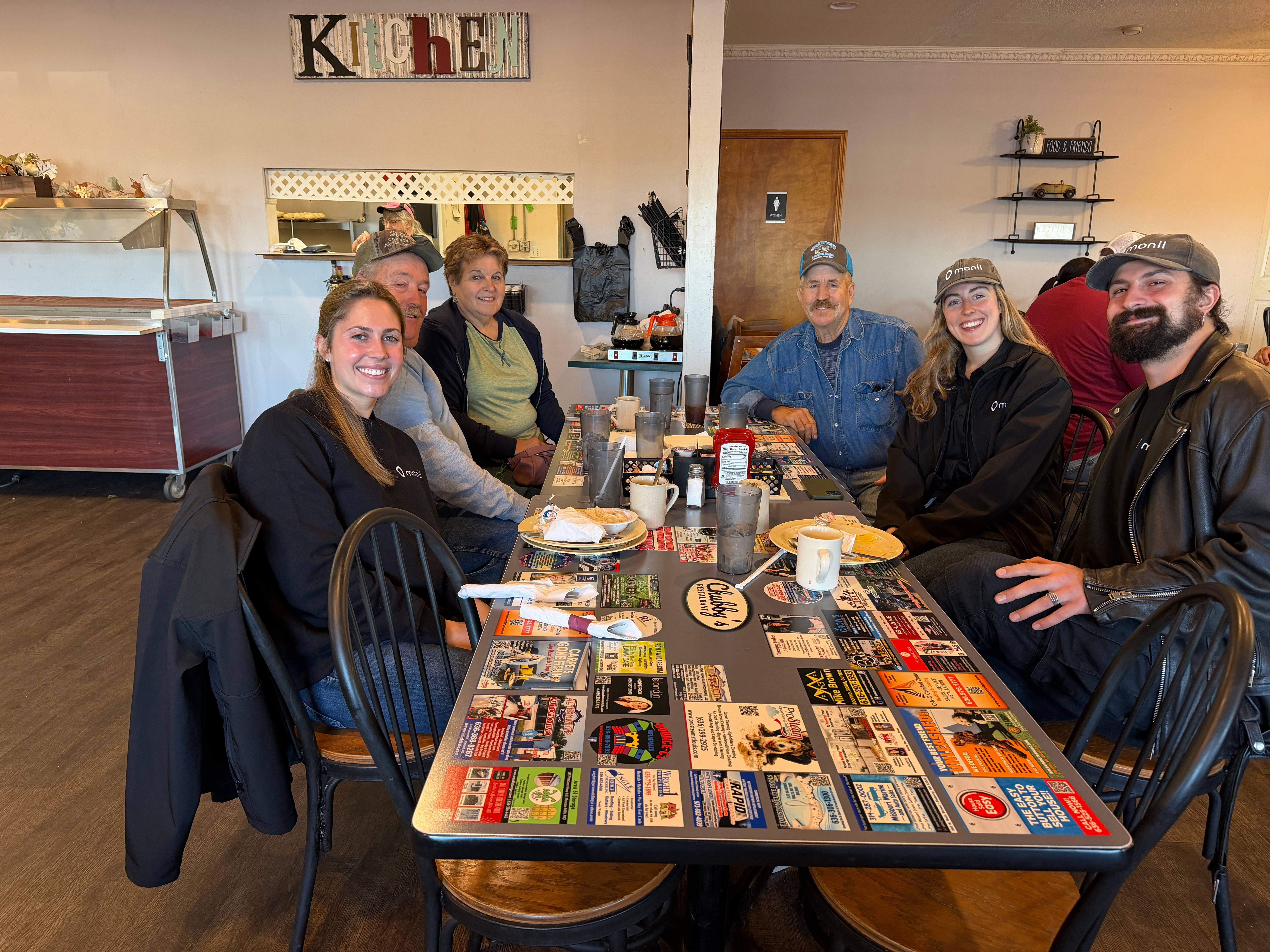 Monil virtual fences team sitting with customers at breakfast. Family friendly company.
