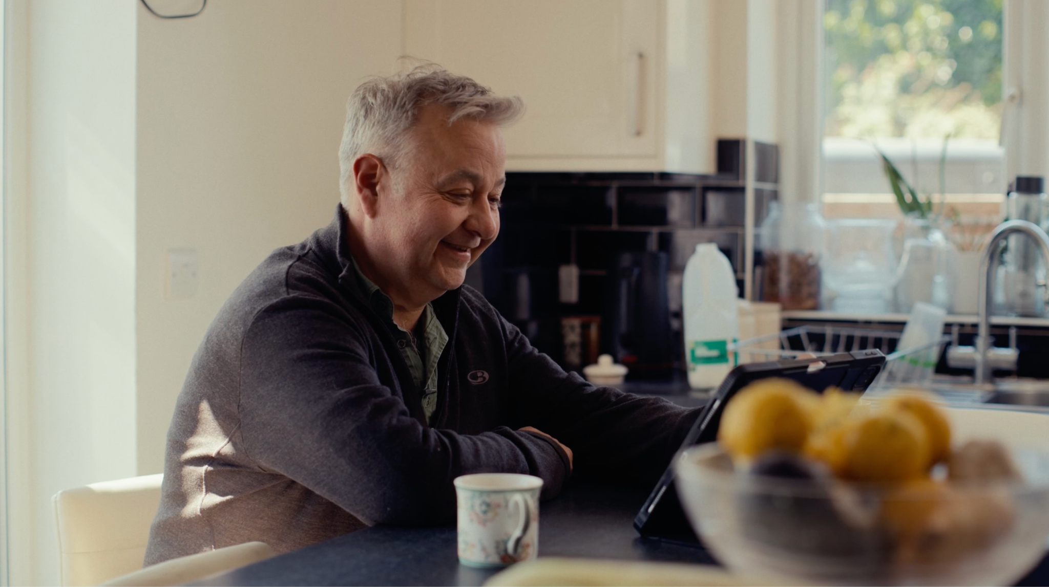 Rob Pratt checking the Monil app while drinking his morning coffee