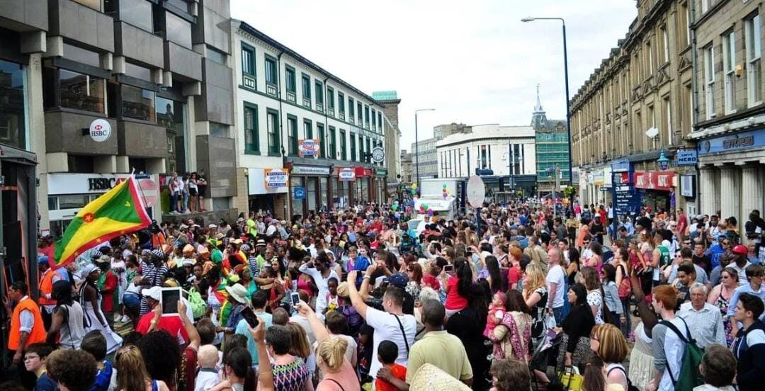 A packed crowd lining the street on carnival day.