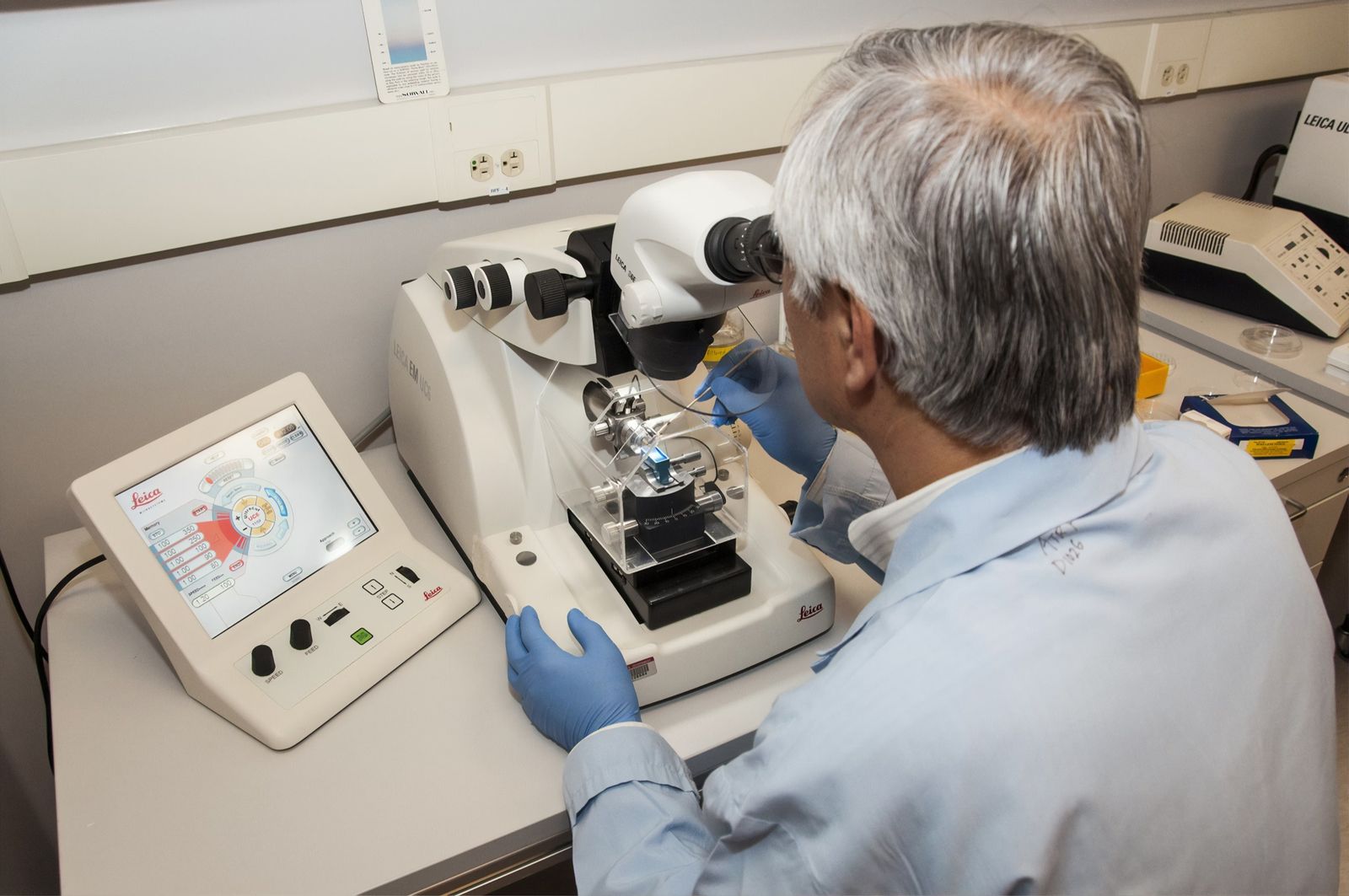 Scientist looking into a microscope in a laboratory