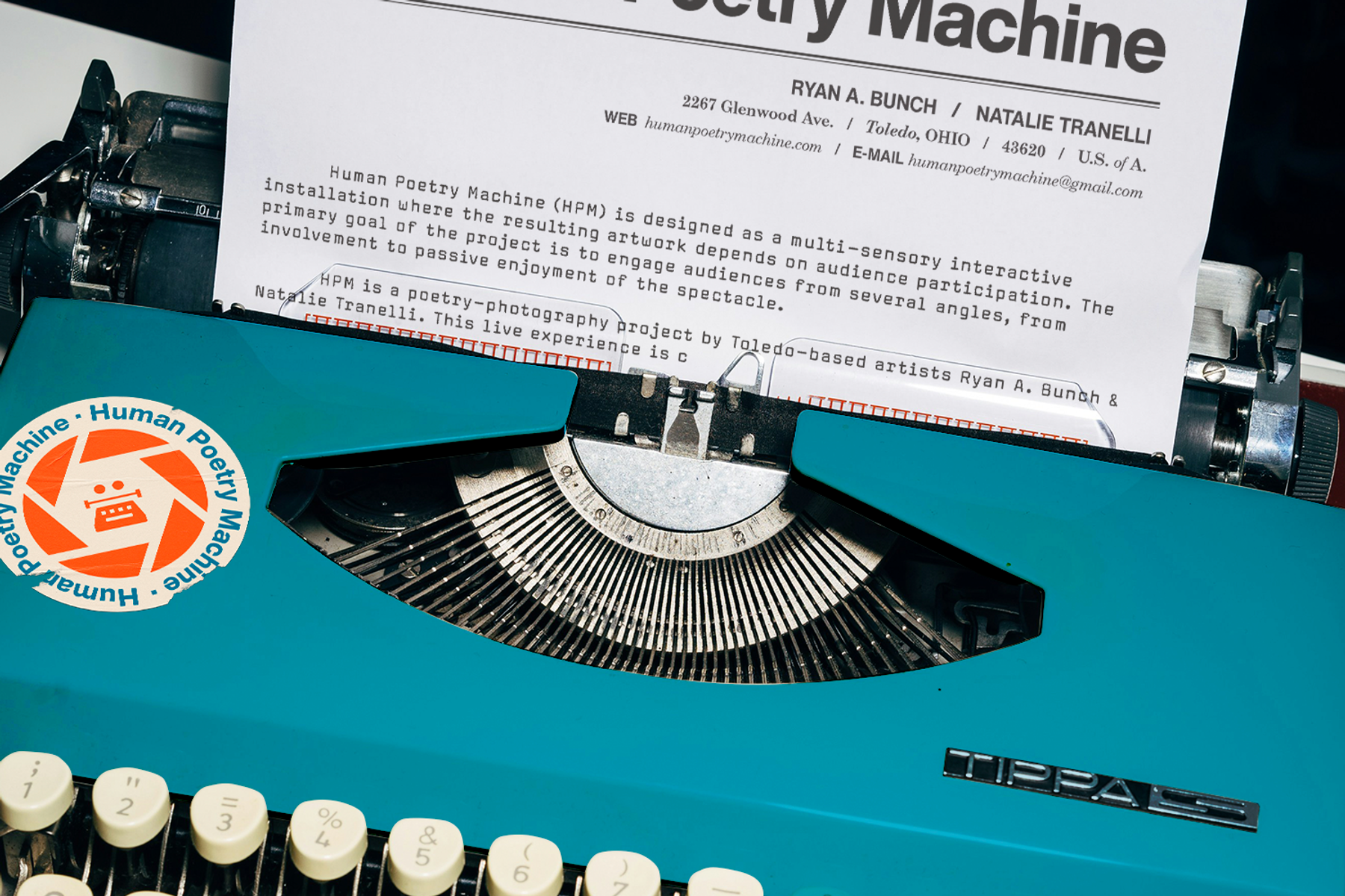 Vintage typewriter with a Human Poetry Machine Sticker on it