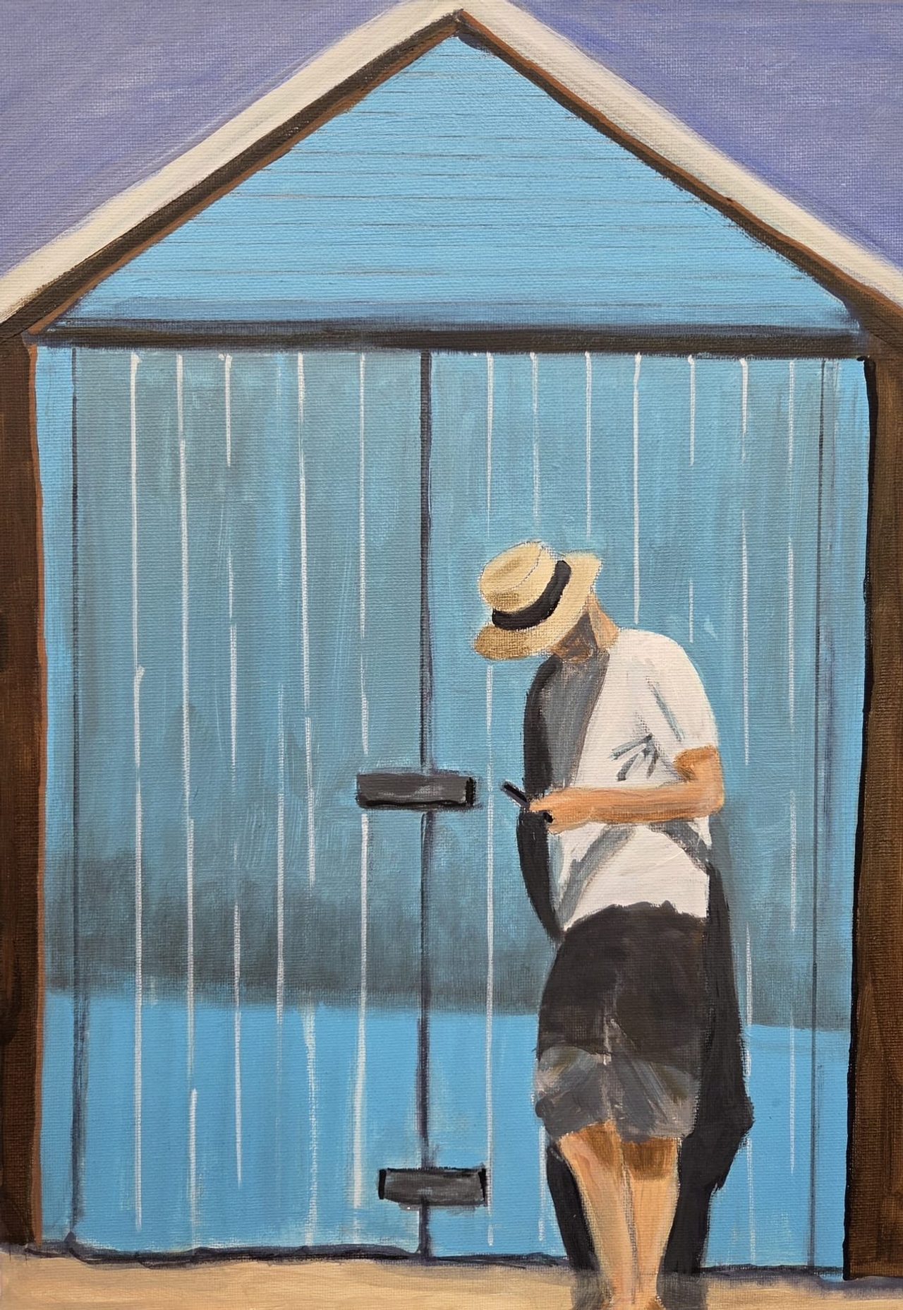 A man in a straw hat looking at his phone in front of a pale blue beach hut
