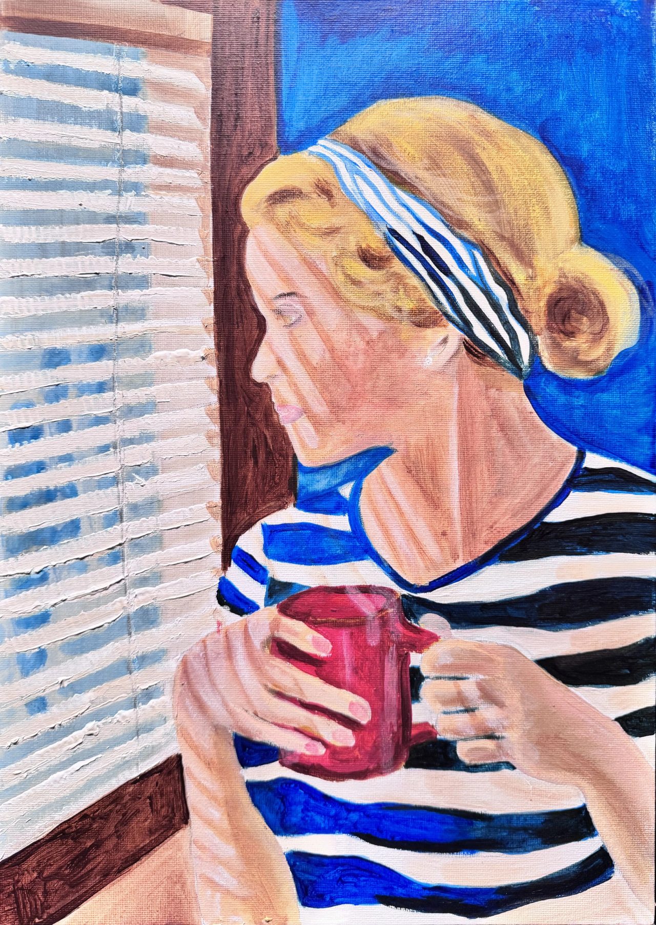 A woman in a striped top and headband holding a red mug by a window with blinds