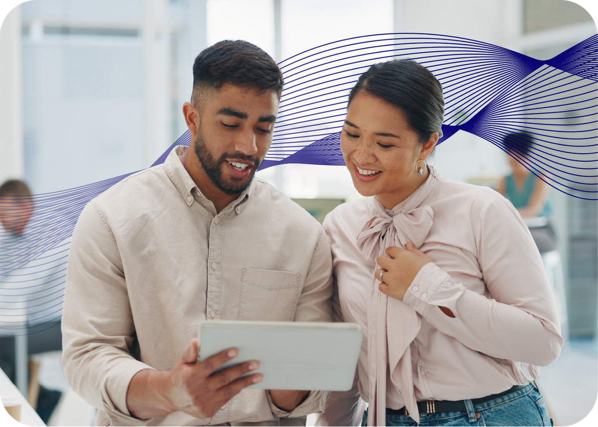 Two people looking at a screen with an AI data wave behind them