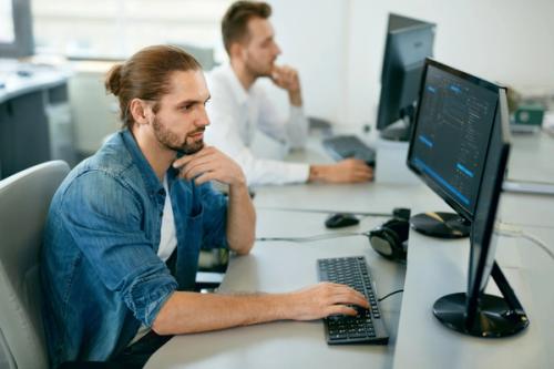 Two people sat at their computers working