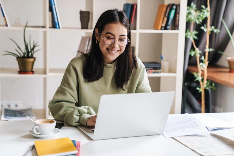 Person working on a laptop smiling