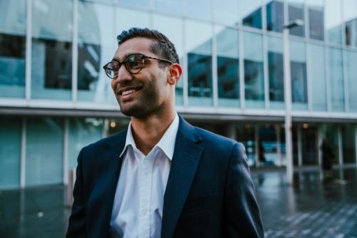 Person dressed smartly outside smiling