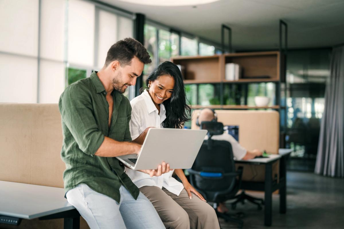 Two people looking at a laptop together