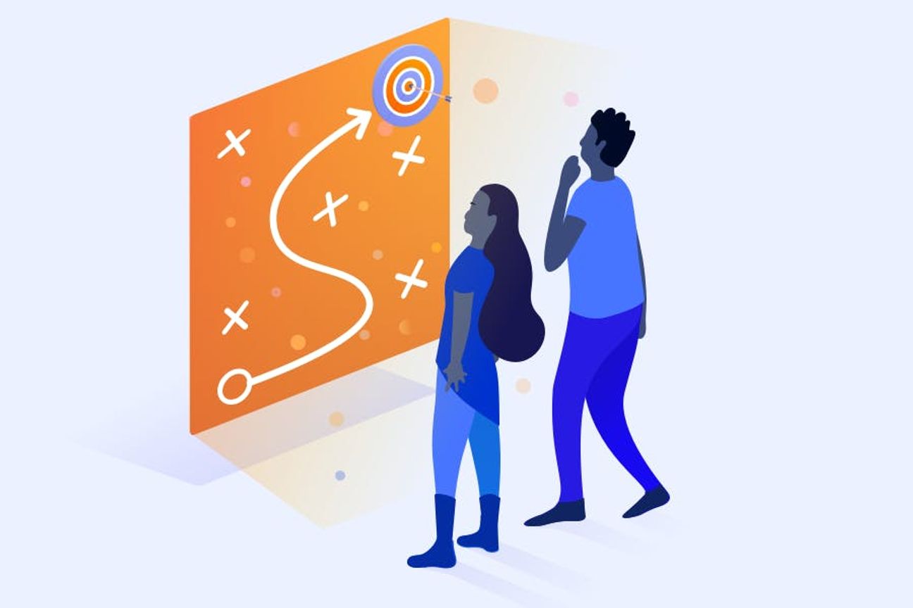 Two people looking at a map of a path to becoming compliant.
